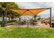 Outdoor picnic area with covered seating, BBQ grills, and green space at 3318 N Decatur Blvd # 1020, Las Vegas, NV 89130