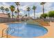 Community pool area with palm trees and clear blue water at 3318 N Decatur Blvd # 1020, Las Vegas, NV 89130