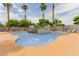 Community pool featuring a gradual entrance, a waterfall feature, and several palm trees at 3318 N Decatur Blvd # 1020, Las Vegas, NV 89130