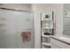 Bathroom detail showcasing frosted glass shower doors and a corner shelf for storage at 3531 Montepulciano Ln, Henderson, NV 89044