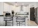 Stylish kitchen with black and white accents, updated appliances, and breakfast bar at 3531 Montepulciano Ln, Henderson, NV 89044