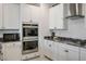 Modern kitchen featuring stainless steel appliances, white cabinets, and granite countertops at 3531 Montepulciano Ln, Henderson, NV 89044