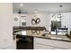 Open concept kitchen and living area with granite countertop and stainless dishwasher at 3531 Montepulciano Ln, Henderson, NV 89044