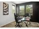 Home office with sleek black desk and ample natural light from the windows at 3531 Montepulciano Ln, Henderson, NV 89044