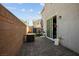 Outdoor patio with brick flooring, a built-in grill, and sliding glass door access to the home at 3531 Montepulciano Ln, Henderson, NV 89044