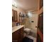 Bathroom featuring a vanity, toilet, and glass-enclosed shower, accented by decorative door at 3930 University Center Dr # 612, Las Vegas, NV 89119