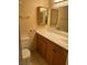 Bright bathroom with a marble countertop, warm oak cabinets, and a convenient single-sink vanity at 3930 University Center Dr # 612, Las Vegas, NV 89119