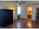 Spacious bedroom with wood flooring, bathroom access and decorative cabinet at 3930 University Center Dr # 612, Las Vegas, NV 89119