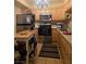 Compact kitchen with stainless steel appliances, wooden cabinets and functional island at 3930 University Center Dr # 612, Las Vegas, NV 89119