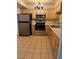 Well-lit kitchen featuring stainless steel appliances and tiled flooring at 3930 University Center Dr # 612, Las Vegas, NV 89119
