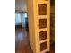 View of the living room from the walk-in closet; cabinet door with artistic carvings at 3930 University Center Dr # 612, Las Vegas, NV 89119