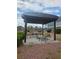 Outdoor patio with table, chairs and shade structure at 3930 University Center Dr # 612, Las Vegas, NV 89119