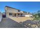 Generous backyard featuring a covered patio, slider access, and easy-care gravel landscaping at 405 Prairie Moon Ave, North Las Vegas, NV 89084