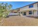 Expansive backyard with low-maintenance gravel landscaping and a covered patio, ideal for relaxation and entertaining at 405 Prairie Moon Ave, North Las Vegas, NV 89084