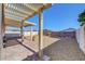 Backyard featuring a covered patio with a pergola, gravel landscaping, a small garden, and a white fence at 405 Prairie Moon Ave, North Las Vegas, NV 89084