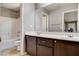 Bathroom featuring double vanity with cabinets, a large mirror, and a separate toilet area at 405 Prairie Moon Ave, North Las Vegas, NV 89084