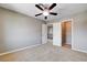 Spacious bedroom featuring neutral walls, carpet, and a ceiling fan with plenty of closet space at 405 Prairie Moon Ave, North Las Vegas, NV 89084