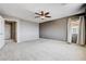 Large bedroom with neutral colors, carpeted floors, and a ceiling fan with open closet space at 405 Prairie Moon Ave, North Las Vegas, NV 89084