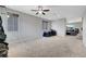 Large bonus room featuring neutral walls, carpet flooring, and a ceiling fan with views to the outdoors at 405 Prairie Moon Ave, North Las Vegas, NV 89084