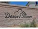 Desert Moon community entrance sign on a brick wall with some vegetation at 405 Prairie Moon Ave, North Las Vegas, NV 89084