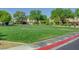 Community green space with grassy field and surrounding homes and trees at 405 Prairie Moon Ave, North Las Vegas, NV 89084