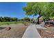 Landscaped community green space with trees, bench, and walking path at 405 Prairie Moon Ave, North Las Vegas, NV 89084