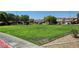 Community green space with large grassy field and surrounding homes at 405 Prairie Moon Ave, North Las Vegas, NV 89084