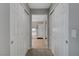 A hallway leading to the ensuite main bathroom with double doors and carpet at 405 Prairie Moon Ave, North Las Vegas, NV 89084