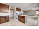Open kitchen with wood cabinets, granite countertops and stainless steel refrigerator at 405 Prairie Moon Ave, North Las Vegas, NV 89084