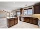 Open concept kitchen with a central island, wood cabinets, and tile flooring at 405 Prairie Moon Ave, North Las Vegas, NV 89084