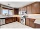 Charming kitchen showcasing wood cabinetry and stainless steel appliances at 405 Prairie Moon Ave, North Las Vegas, NV 89084