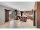 Spacious kitchen with stainless appliances, granite counters, wood cabinets and tiled floor leading to a slider at 405 Prairie Moon Ave, North Las Vegas, NV 89084