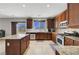 Spacious kitchen featuring wood cabinetry, stainless steel appliances, granite counters, and an island at 405 Prairie Moon Ave, North Las Vegas, NV 89084
