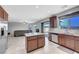 Modern kitchen showcasing stainless steel appliances, granite countertops, and an open layout to the living area at 405 Prairie Moon Ave, North Las Vegas, NV 89084