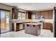 Well-lit kitchen featuring wood cabinets, stainless steel appliances, and granite countertops at 405 Prairie Moon Ave, North Las Vegas, NV 89084