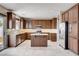 Bright kitchen featuring an island, wood cabinets and stainless steel appliances at 405 Prairie Moon Ave, North Las Vegas, NV 89084