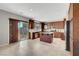 Spacious kitchen featuring wood cabinetry, stainless steel appliances, granite counters, and tile flooring at 405 Prairie Moon Ave, North Las Vegas, NV 89084