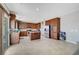 Bright kitchen featuring granite countertops, a center island, stainless steel appliances, wood cabinetry, and tile flooring at 405 Prairie Moon Ave, North Las Vegas, NV 89084