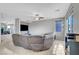 Expansive living room with large sectional sofa, neutral walls, and carpet flooring providing a comfortable living space at 405 Prairie Moon Ave, North Las Vegas, NV 89084