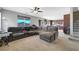 Comfortable living room featuring plush carpeting, a large sectional sofa, and an open floor plan at 405 Prairie Moon Ave, North Las Vegas, NV 89084
