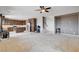 Open-concept living room with an adjacent kitchen featuring stainless steel appliances and a central island with bar seating at 405 Prairie Moon Ave, North Las Vegas, NV 89084