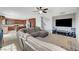 Spacious living room with kitchen view, stairs, large sectional sofa, and carpeted floors at 405 Prairie Moon Ave, North Las Vegas, NV 89084