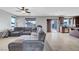 Comfortable living room with tile floors, large sectional sofa, and easy access to the backyard through sliding glass doors at 405 Prairie Moon Ave, North Las Vegas, NV 89084