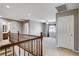 Second floor landing and wooden railing with entry to the bedrooms with carpeting and ceiling fans at 405 Prairie Moon Ave, North Las Vegas, NV 89084