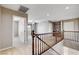 Upstairs loft area with wood railing, carpet flooring, multiple entry ways, and natural light at 405 Prairie Moon Ave, North Las Vegas, NV 89084