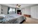 This main bedroom boasts carpet, a ceiling fan, a window, and lots of space at 405 Prairie Moon Ave, North Las Vegas, NV 89084