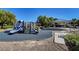Community playground featuring slides, climbing areas and picnic tables, with mature trees for shade at 405 Prairie Moon Ave, North Las Vegas, NV 89084