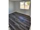 A bright bedroom features vinyl flooring and a large window with an outside view at 4231 E Kellogg Rd, Pahrump, NV 89061