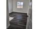 A cozy bedroom with vinyl plank flooring is illuminated by a window with a view at 4231 E Kellogg Rd, Pahrump, NV 89061