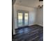 Dining area features gray vinyl floors, backyard access through french doors, and a modern light fixture at 4231 E Kellogg Rd, Pahrump, NV 89061